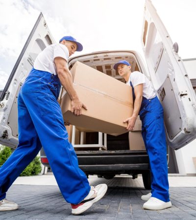 two-removal-company-workers-unloading-boxes-furniture-from-minibus-min